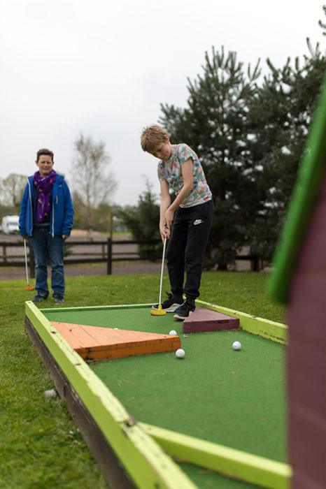 child playing mini golf